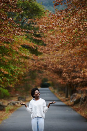 Shot of a young woman enjoying the outdoors on an autumn day