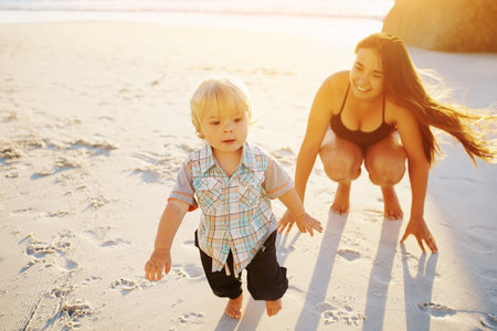 Shot of a mother bonding with her little son at the beach