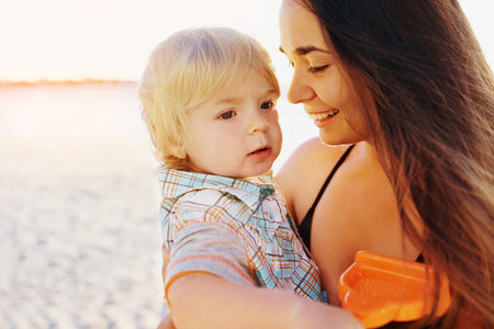 Shot of a mother bonding with her little son at the beachの写真素材
