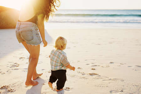 Shot of a mother bonding with her little son at the beachの写真素材