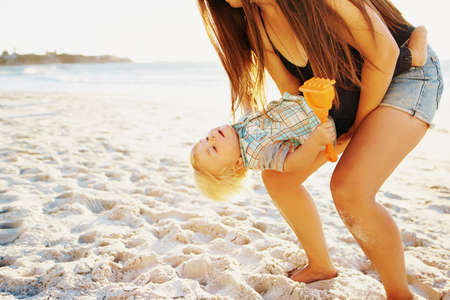 Shot of a mother bonding with her little son at the beachの写真素材