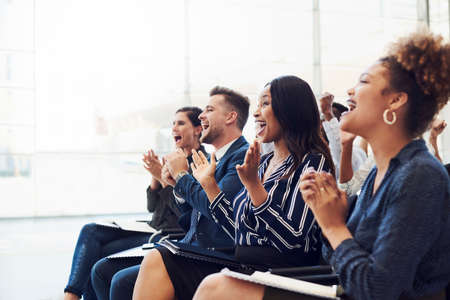 Shot of a group of businesspeople clapping during a conferenceの写真素材
