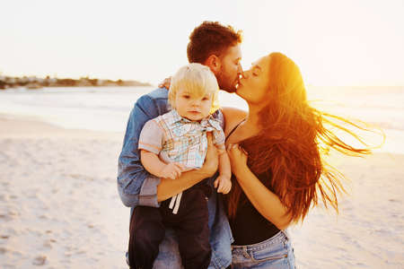 Shot of a happy young family having a fun day at the beachの写真素材
