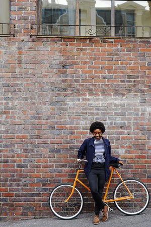 Shot of a young woman traveling through town with her bicycle