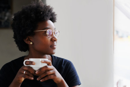Cropped shot of a young woman in a coffee shopの写真素材