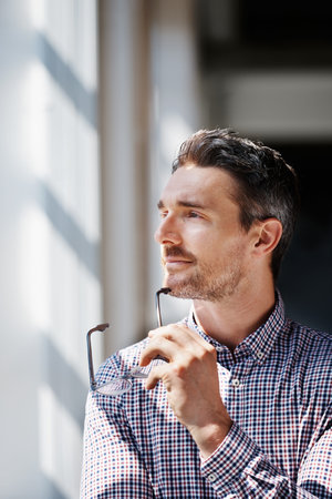 Cropped shot of a mature businessman looking thoughtful while standing in an office