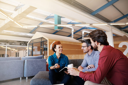 Cropped shot of a group of designers brainstorming together in an office
