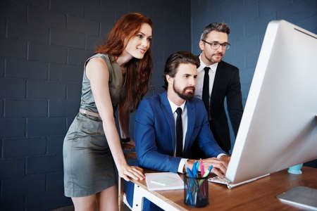 Cropped shot of corporate businesspeople working together in an officeの写真素材