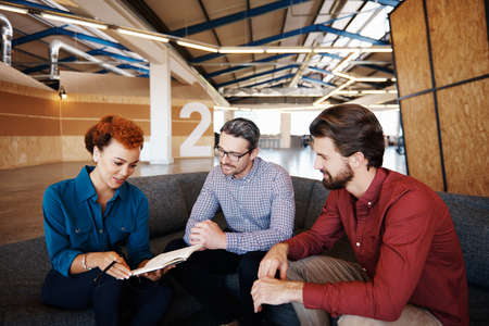 Cropped shot of a group of designers brainstorming together in an officeの写真素材