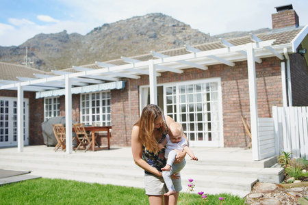Shot of an adorable baby girl exploring the garden with her mother at home