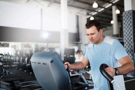 Shot of a mature man exercising on the treadmill at the gymの写真素材