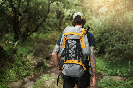 Rearview shot of a young man out on a hike