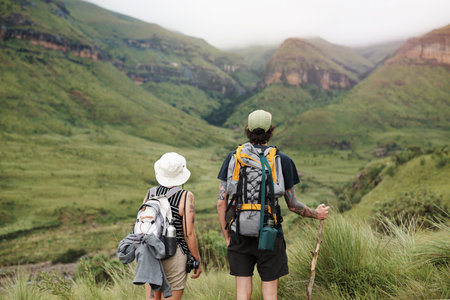 Rearview shot of a young couple out on a hike through the mountains