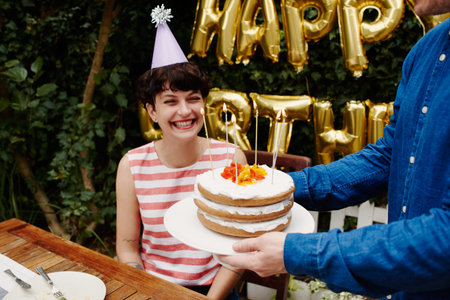 Cropped shot of a group of friends celebrating a birthday outdoors