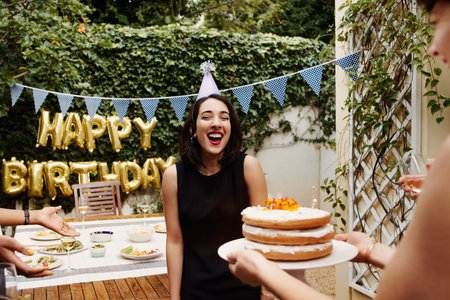 Cropped shot of a group of friends celebrating a birthday outdoors