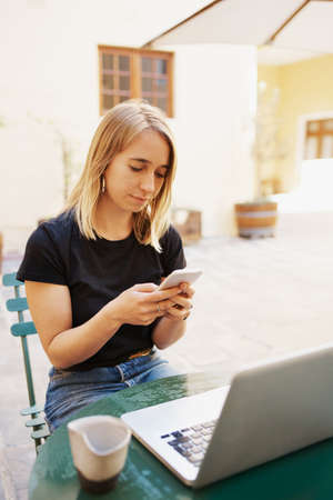 Cropped shot of an attractive young woman using a laptop at a cafeの写真素材
