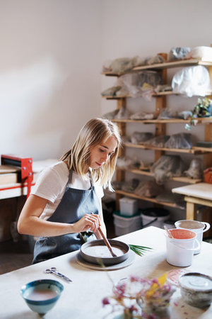 Cropped shot of an attractive young female artisan working in her pottery workshop