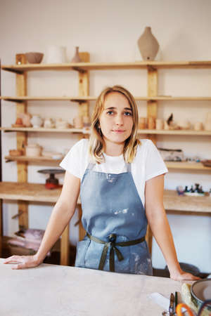 Cropped portrait of an attractive young female artisan working in her pottery workshopの写真素材