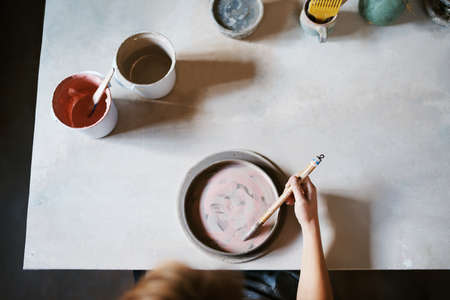 High angle shot of an unrecognizable young female artisan working in her pottery workshopの写真素材
