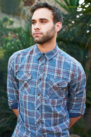 Cropped shot of a handsome young man looking thoughtful while standing outside
