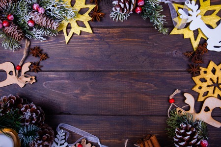 Christmas or new year wooden background framed with season decoration. Winter holiday theme. Space for text and wishesの写真素材