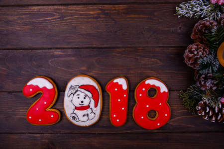 Christmas or new year wooden background framed with season decoration and numbers. Winter holiday theme. Space for text and wishesの写真素材