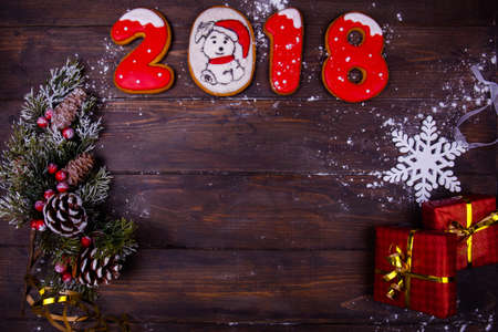 Christmas or new year wooden background framed with season decoration,numbers, gift. Winter holiday theme. Space for text and wishesの写真素材
