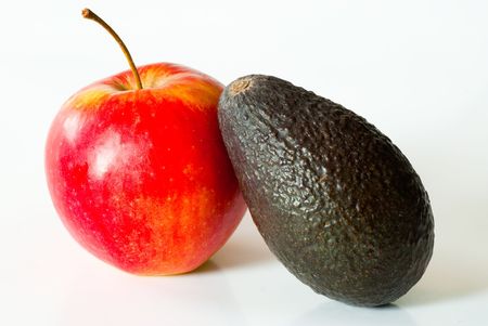 A single avocado and a single apple on a white backgroundの写真素材