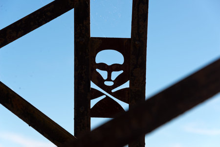 skull and crossbones warning sign on high voltage tower in moroccoの写真素材