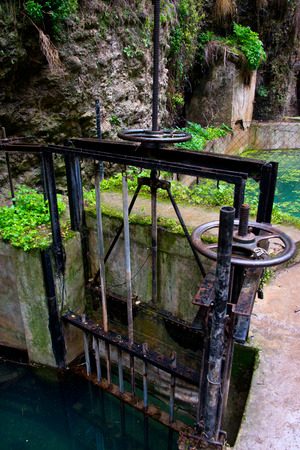 irrigation sluice system with rusty shutoff wheel in ronda, andalusia, spainの写真素材