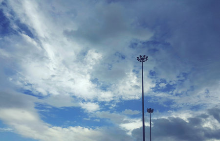 Lamp post electricity industry on street with sky and clouds background.の写真素材