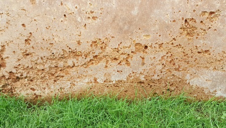 Textures and design by nature of a rammed earth wall.Some of the walls covered with grass.Cracks and corrosive in the wall. Nature orange background.wallpaper,copy spaceの写真素材