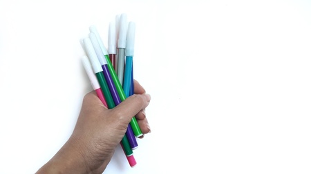 Hand grip colorful magic pens on white background.の写真素材
