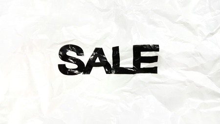 word "sale" isolated on crumpled white plastic background.の写真素材