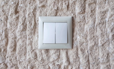 Switches turn off the shore light in the wall stone is rough.の写真素材