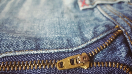 jeans denim background.Sewing details and texture of fabric. Close up jeans zipper with copy space.の写真素材