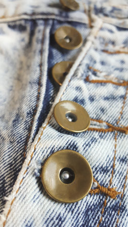 jeans denim background. blue denim with seam of fashion design.Sewing details of button with...
