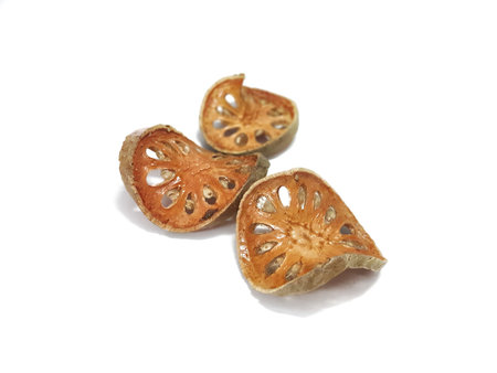 Dry sliced bael fruit on white background with copy space.Aegle marmelos