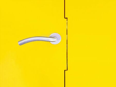 Door handle stainless isolated on yellow background with copy spaceの写真素材