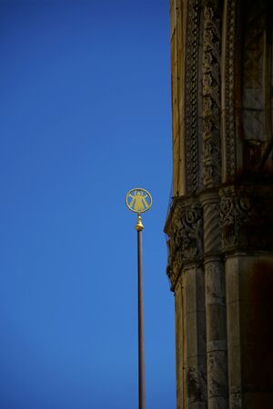 Munich Kindl on pillar in gold with blue sky in backgroundの写真素材