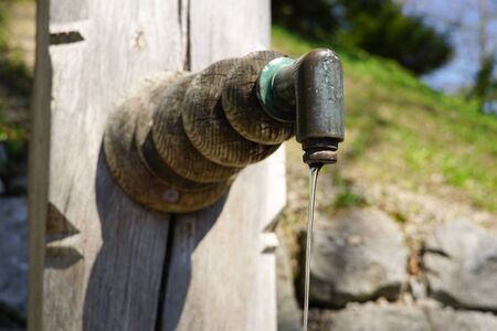 Metal well with wood and fresh waterの写真素材