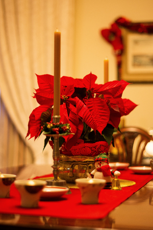 Dining table with holidays decorations on a warm environmentの写真素材