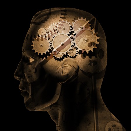 Image of various gears inside of a man's head on a black background.の写真素材