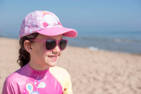 Little girl on vacation posing on the beachの写真素材