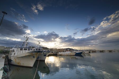 The sunset in the fishing harbor of San Benedetto del Tronto, Italyのeditorial素材
