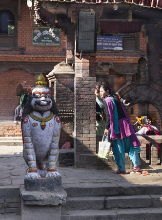 BHAKTAPUR, NEPAL - DECEMBER 2, 2013  local Nepalese unidentified woman goes to the temple in the famous Durbar square of Bhaktapur on December 2, 2013 in Kathmandu valley, Nepal   Bhaktapur is the third largest city in Kathmandu valley のeditorial素材