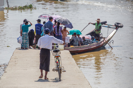 YANGON, MYANMAR - NOVEMBER 22, 2014: several unidentified people take the boat to cross the Yangon...