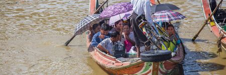 YANGON, MYANMAR - NOVEMBER 22, 2014: several unidentified people take the boat to cross the Yangon...