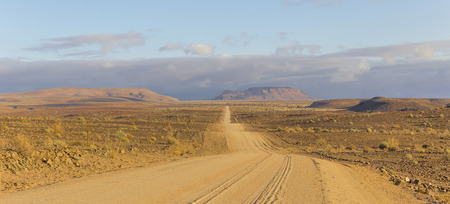 The C12, scenic dirt road in the desert leading to the Fish River Canyon, Namibiaの写真素材