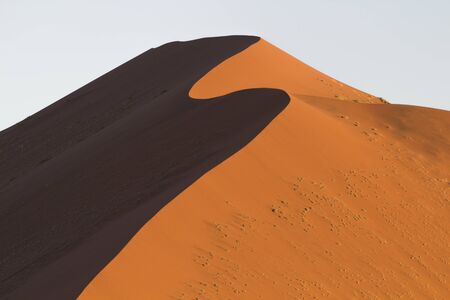 The crest of a red dune in the Namib Desert, in Sossusvlei, in the Namib-Naukluft National Park of Namibiaの写真素材